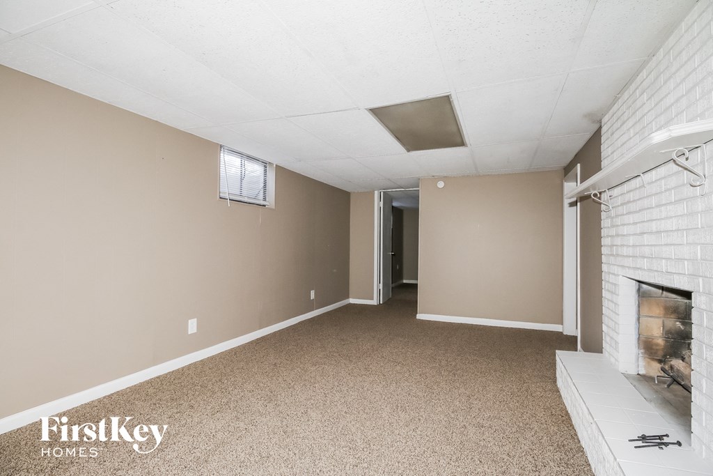 a living room with a fireplace and a carpeted floor