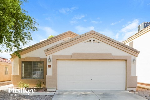 a home with a white garage door in front of it