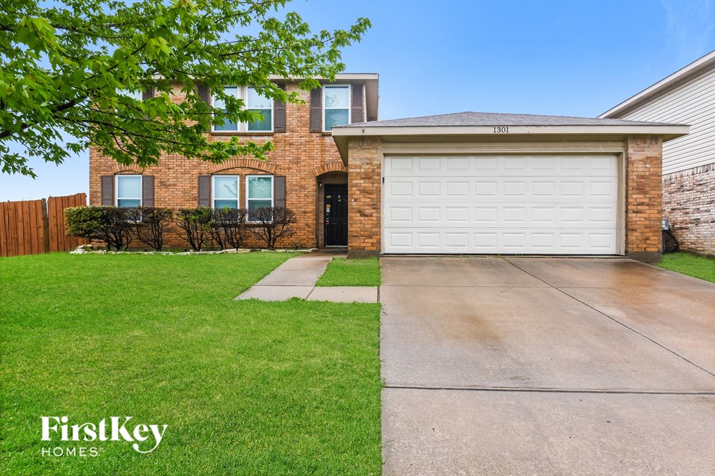 a home with a white garage door in front of it