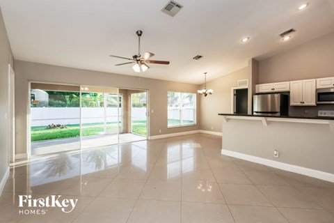 A spacious kitchen and living room with a view of the outdoors.
