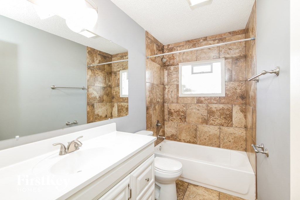 a bathroom with a sink toilet and a tub