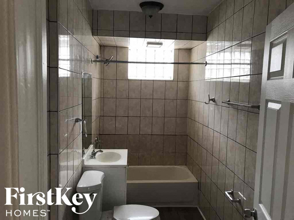 a small bathroom with a sink toilet and a bath tub