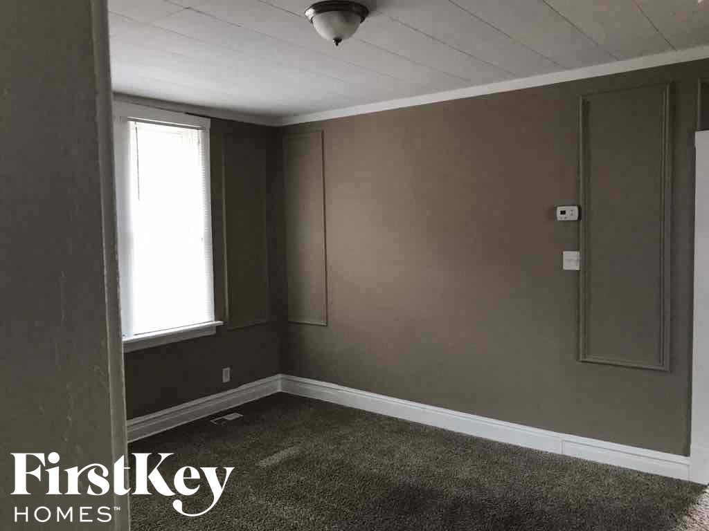 a small room with a window and gray walls