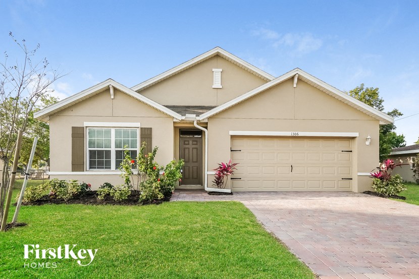 A house with a garage and a driveway is for sale.