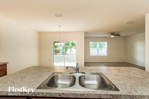 A kitchen with a double sink and a window.