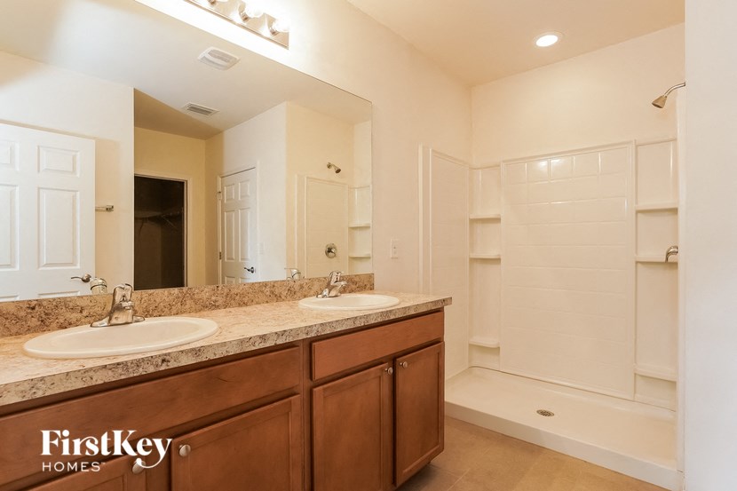 A bathroom with a double sink and a large mirror.