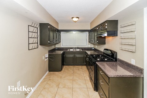 a kitchen with black appliances and granite counter tops