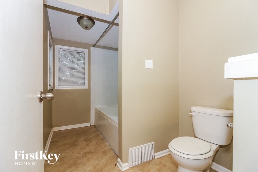 a small bathroom with a toilet and a shower