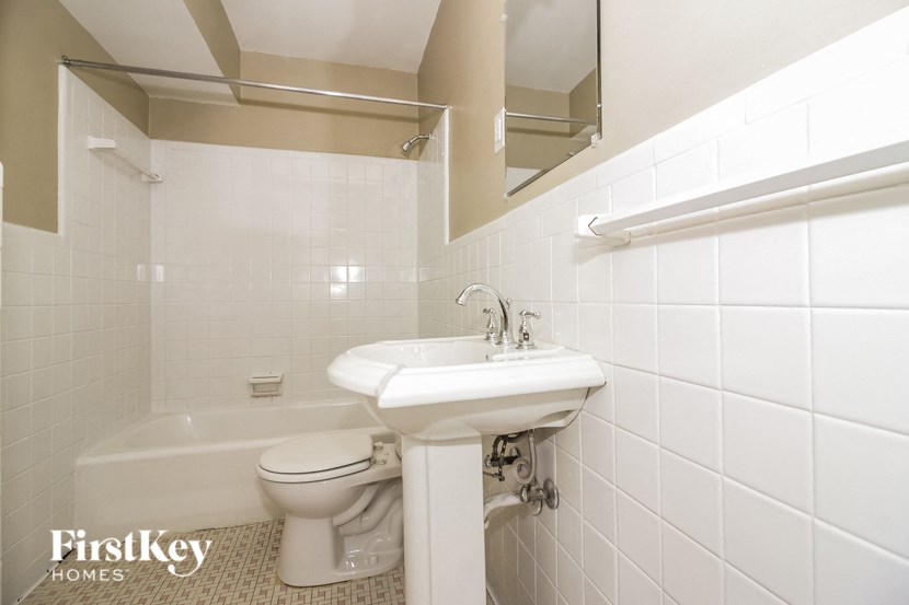 a white bathroom with a sink and a toilet