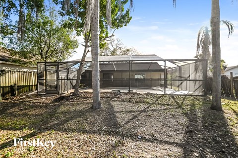 a house with a yard with trees and a fence