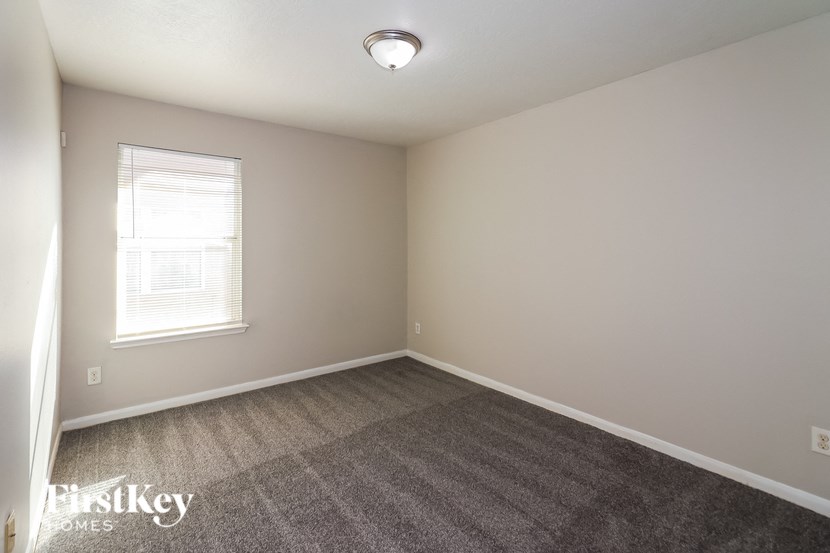 a room with a carpeted floor and a window