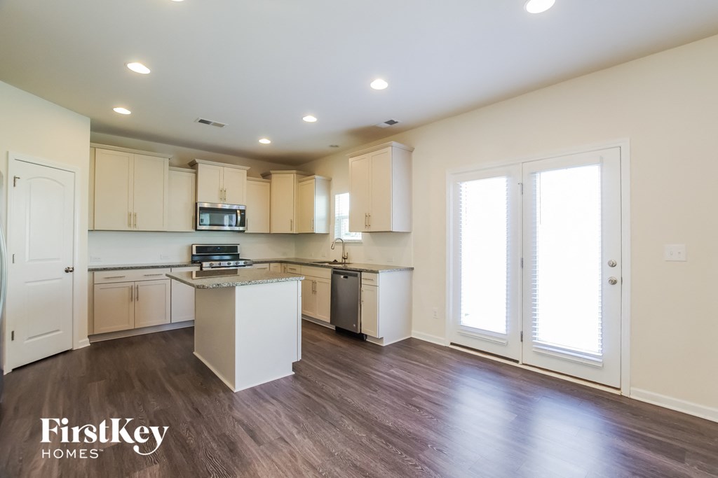 the kitchen is open to the living room and dining room