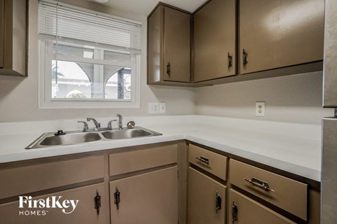 A kitchen with a sink and cabinets.
