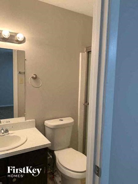 a bathroom with a white toilet and a sink
