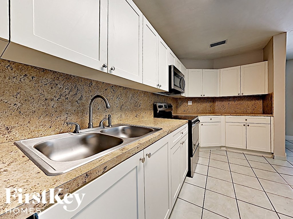 A kitchen with a sink and cabinets.