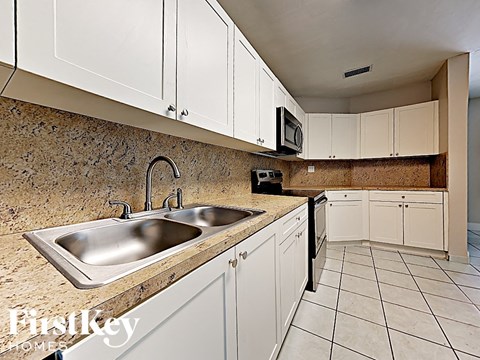 A kitchen with a sink and cabinets.