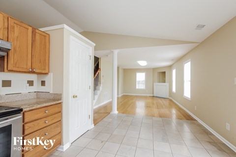A kitchen with wooden cabinets and a white refrigerator.