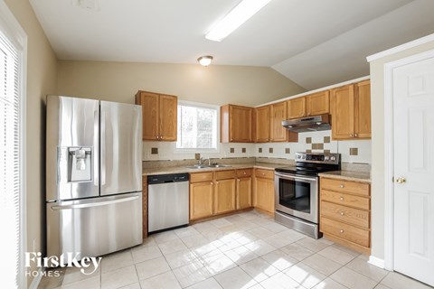A kitchen with wooden cabinets and stainless steel appliances.