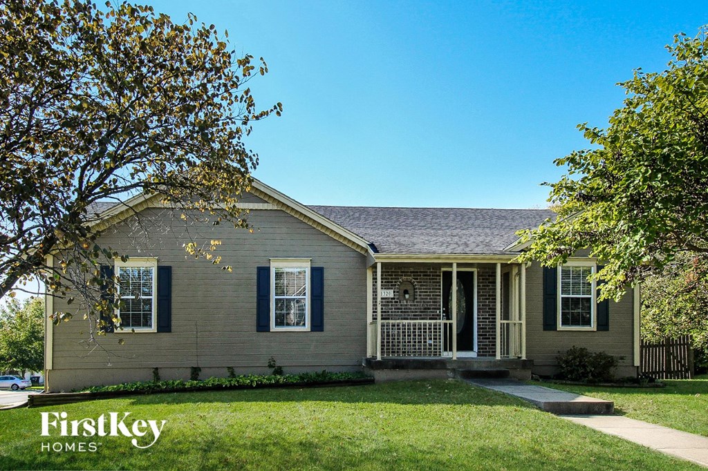 A house with a tree in front of it.