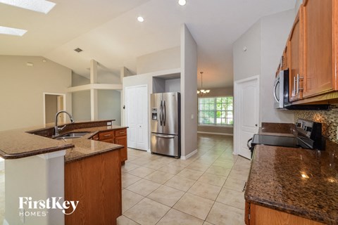 full view of the kitchen with granite counter tops and stainless steel appliances