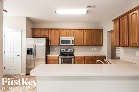 a kitchen with wooden cabinets and stainless steel appliances