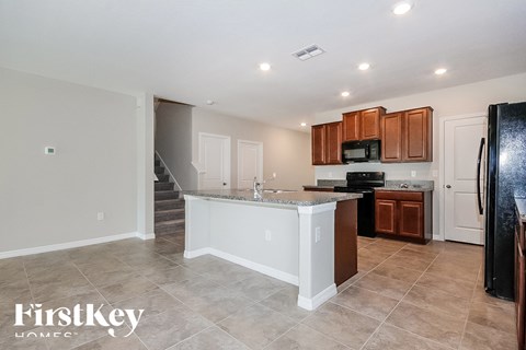 a kitchen with a counter top and a refrigerator