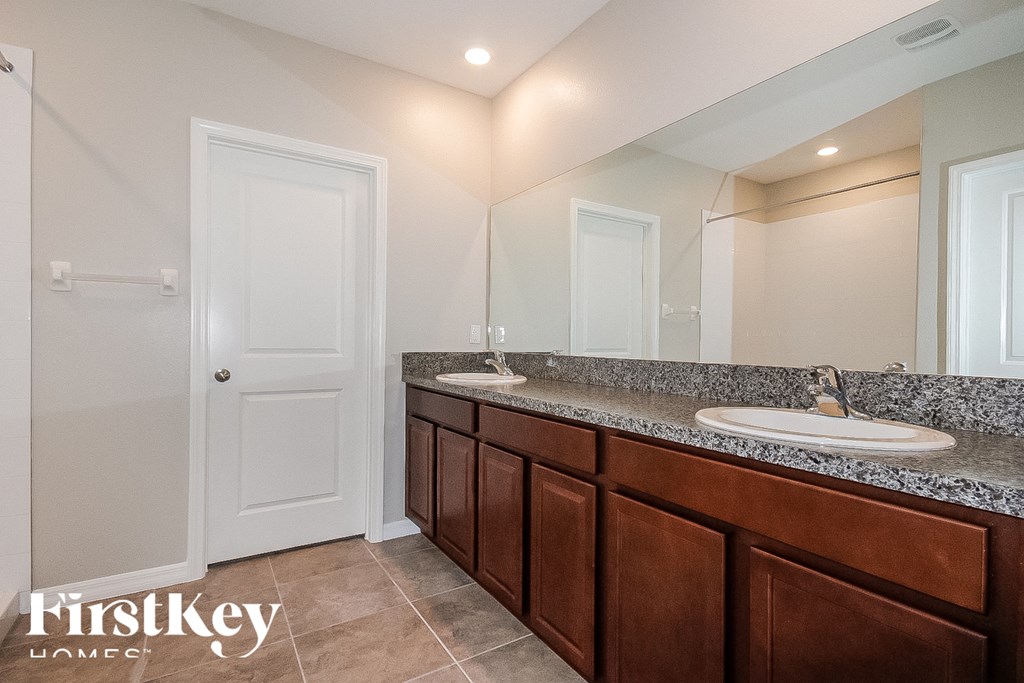 a bathroom with two sinks and a mirror