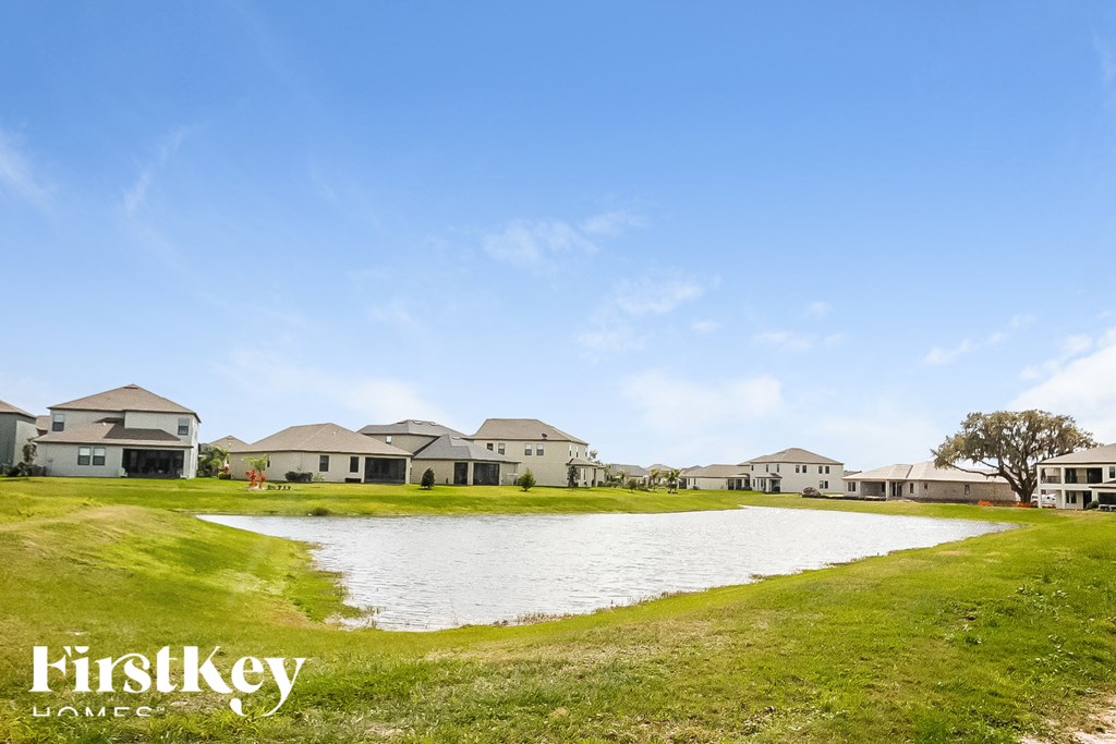 a small body of water in front of a row of houses