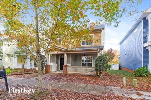 A house with a tree in front of it.