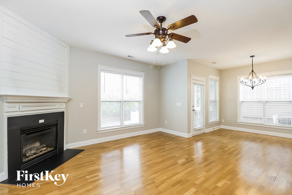 A room with a fireplace and a ceiling fan.