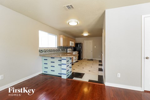 A kitchen area with a counter and a fridge.