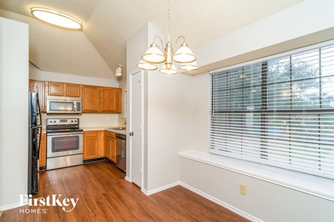 A kitchen with wooden cabinets and stainless steel appliances.