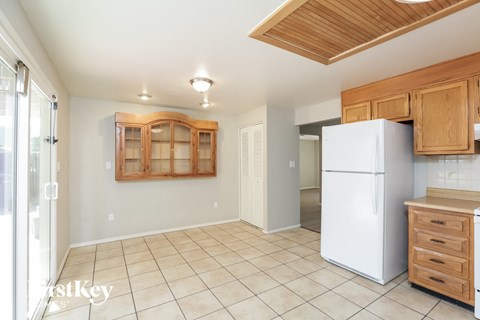 a kitchen with a white refrigerator and cabinets