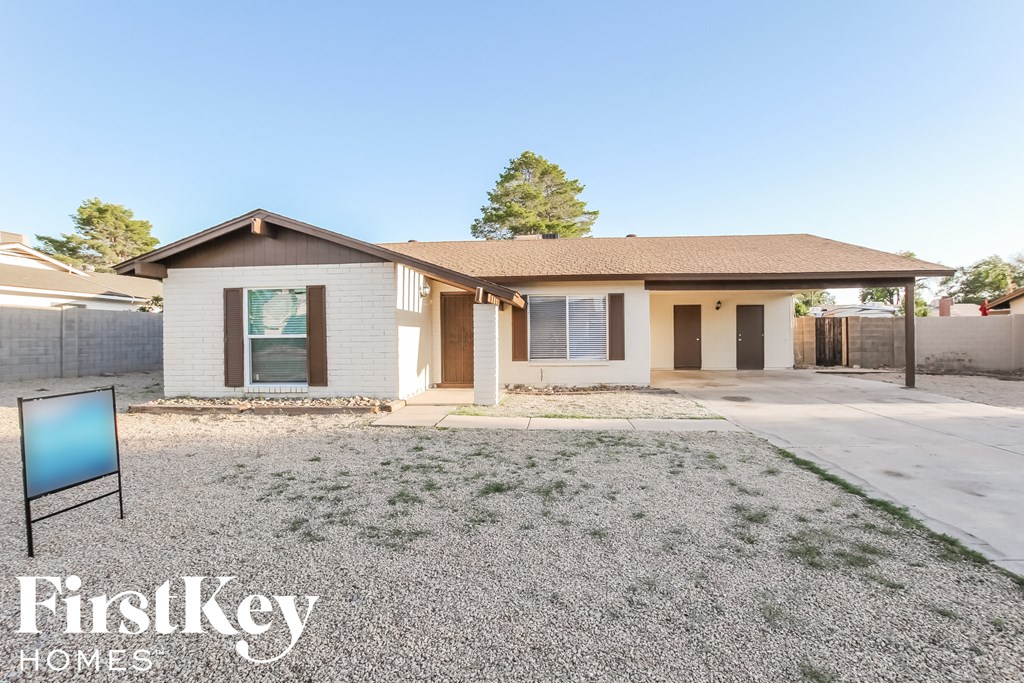 a house with a yard and a sign in front of it