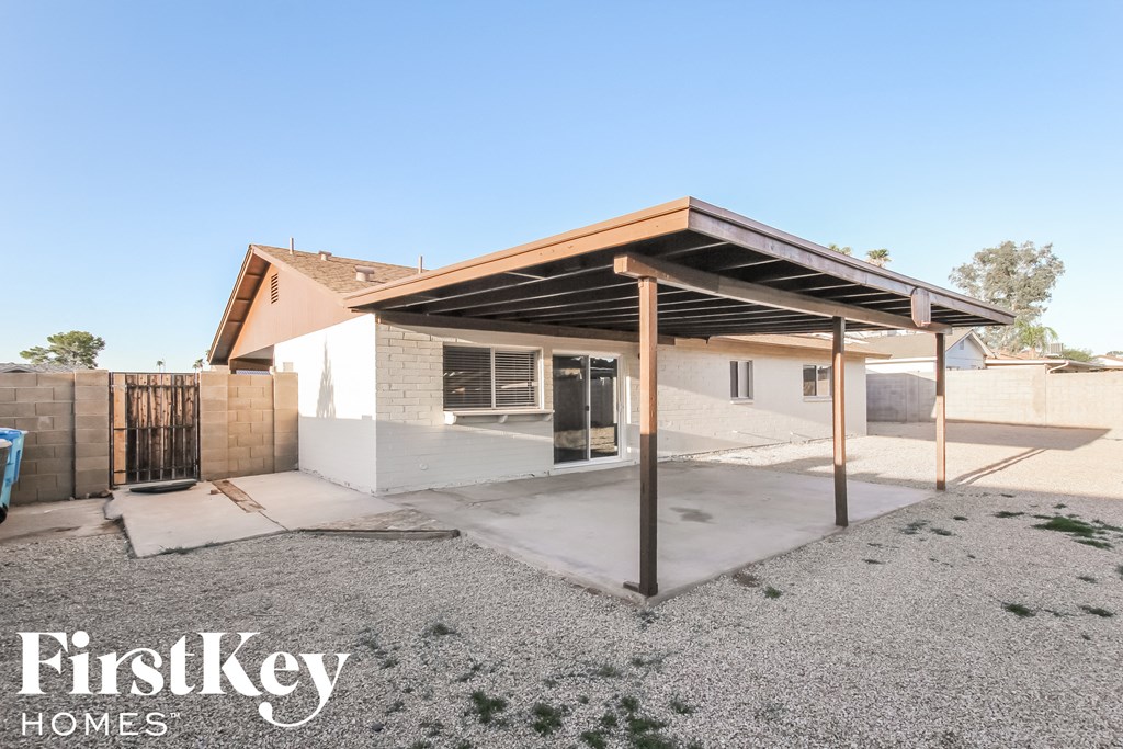 a covered patio in front of a house