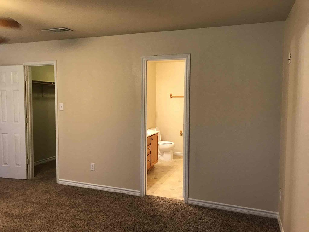 a living room with a door open to a bathroom