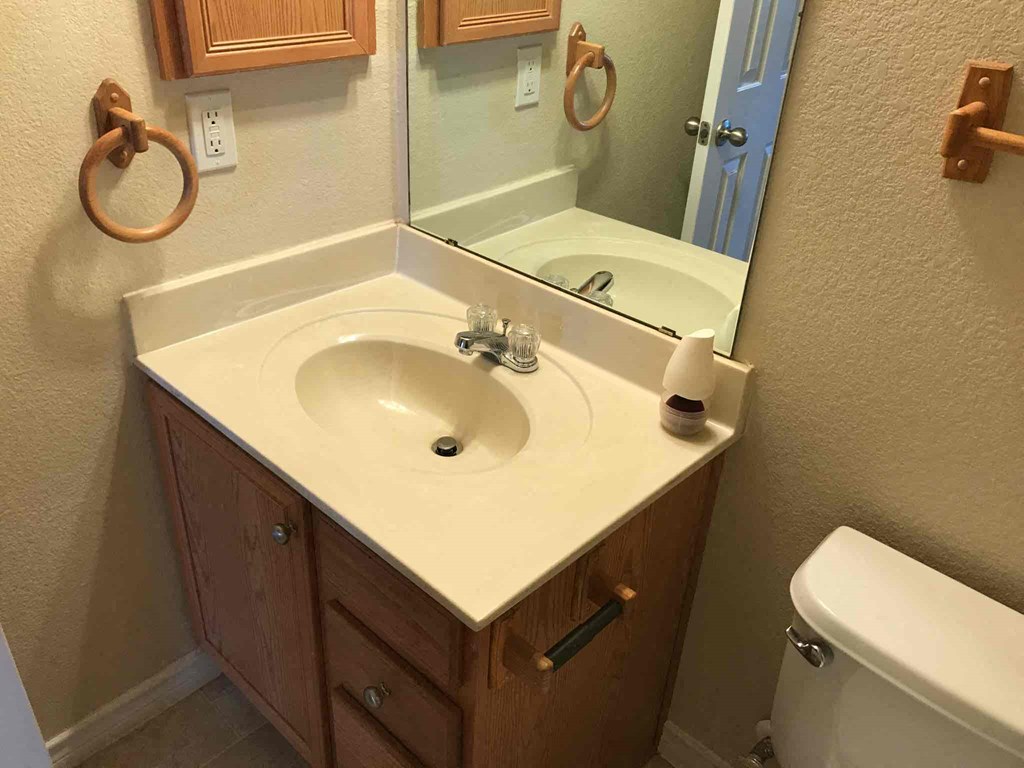 a bathroom with a sink and a mirror and a toilet