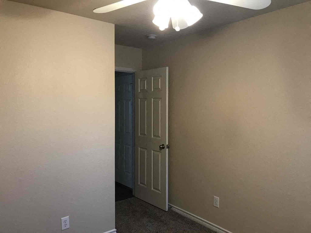 a white door in a room with a white wall and a closet