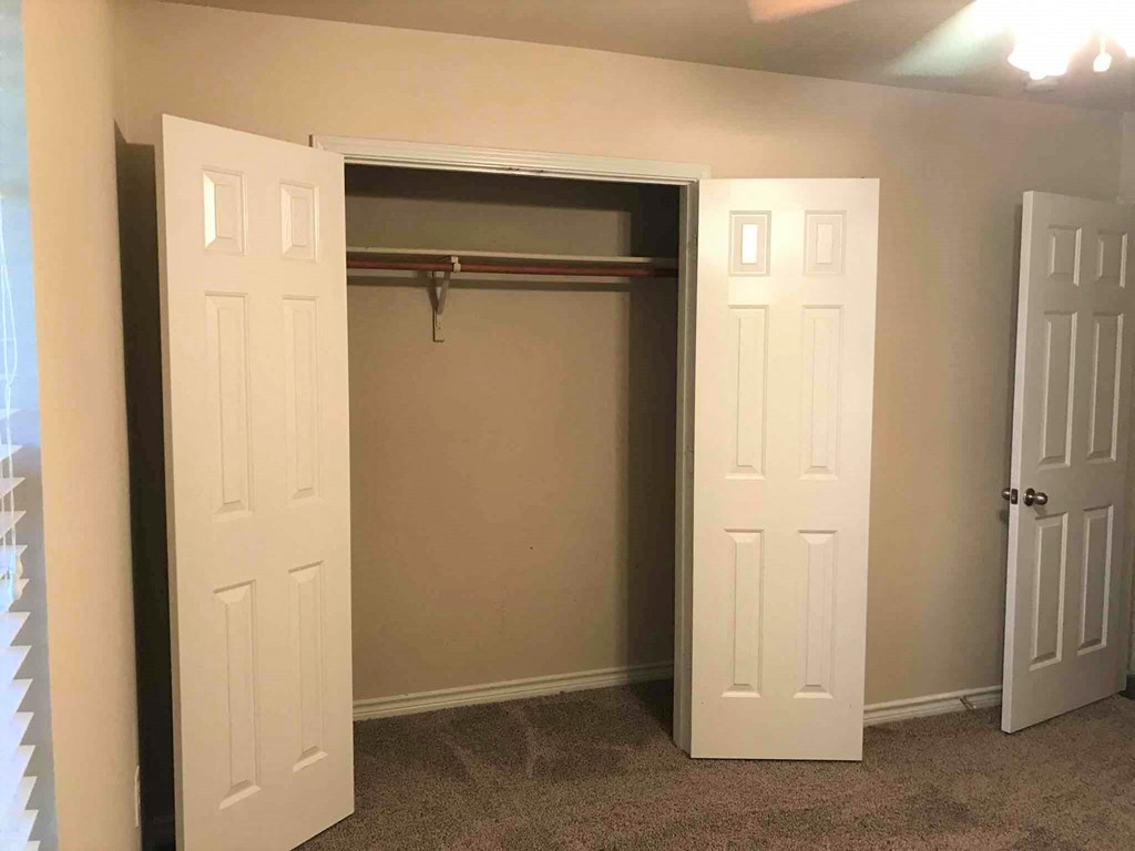 a room with a closet and two doors