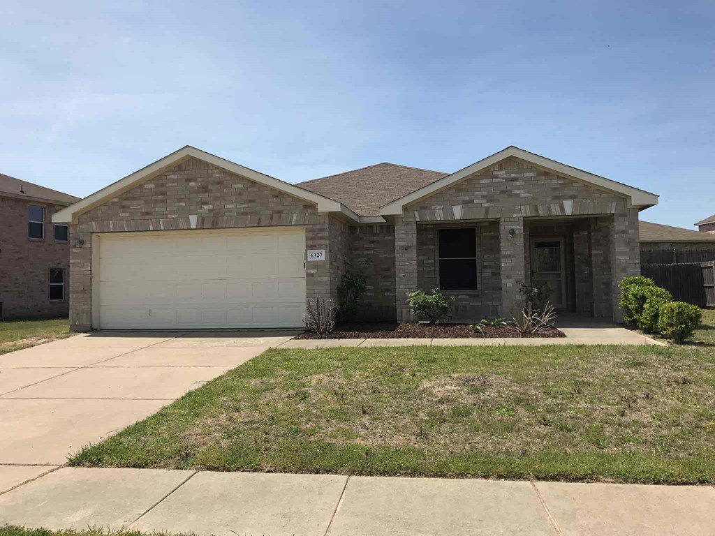 a house with a garage door and a lawn