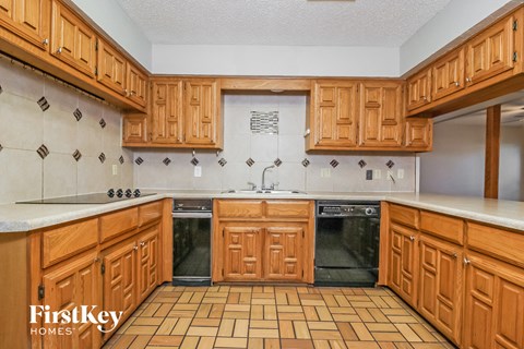 a kitchen with wooden cabinets and black appliances