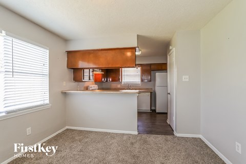 a kitchen with a large window and a white counter top