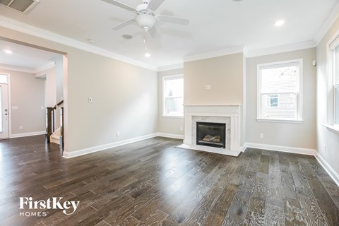 the living room has a fireplace and hardwood floors
