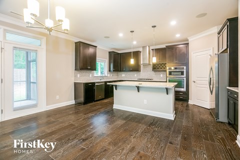 a kitchen with dark wood cabinets and a white counter top
