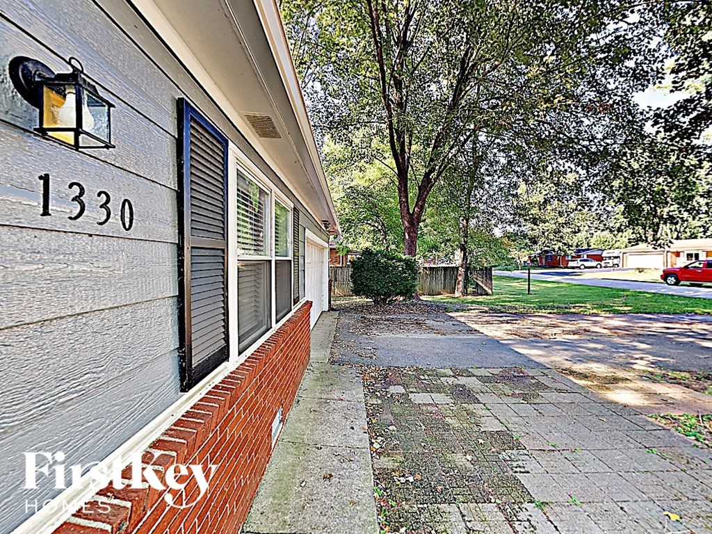 the side of a building with a brick sidewalk
