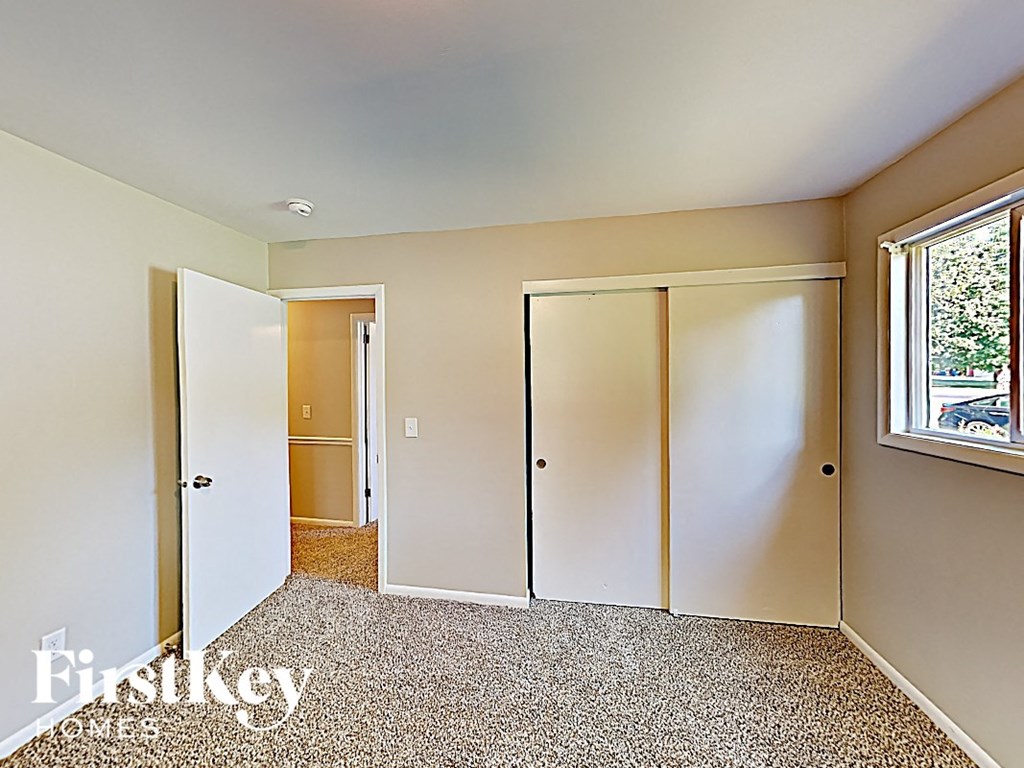 an image of a bedroom with mirrored closet doors
