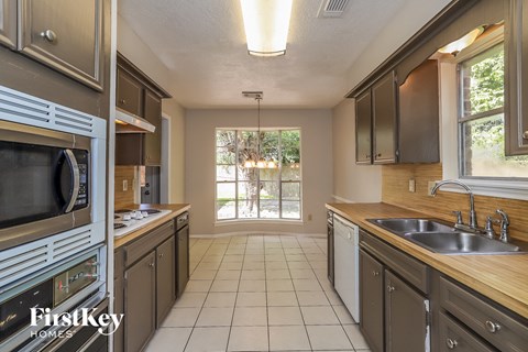 a kitchen with stainless steel appliances and wooden counter tops