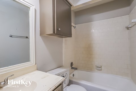 a small bathroom with a tub and a toilet and a sink