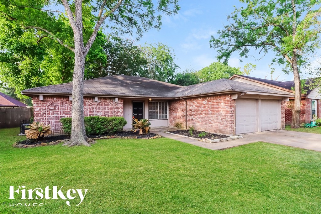 A brick house with a tree in front of it.