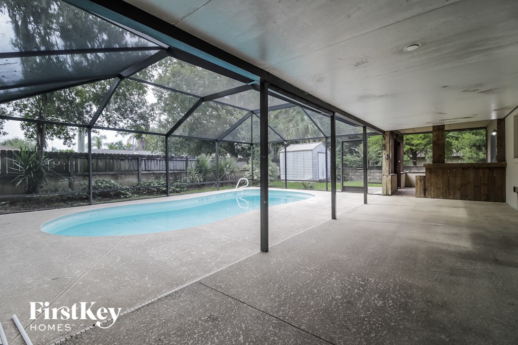 a swimming pool in the middle of a room with glass walls